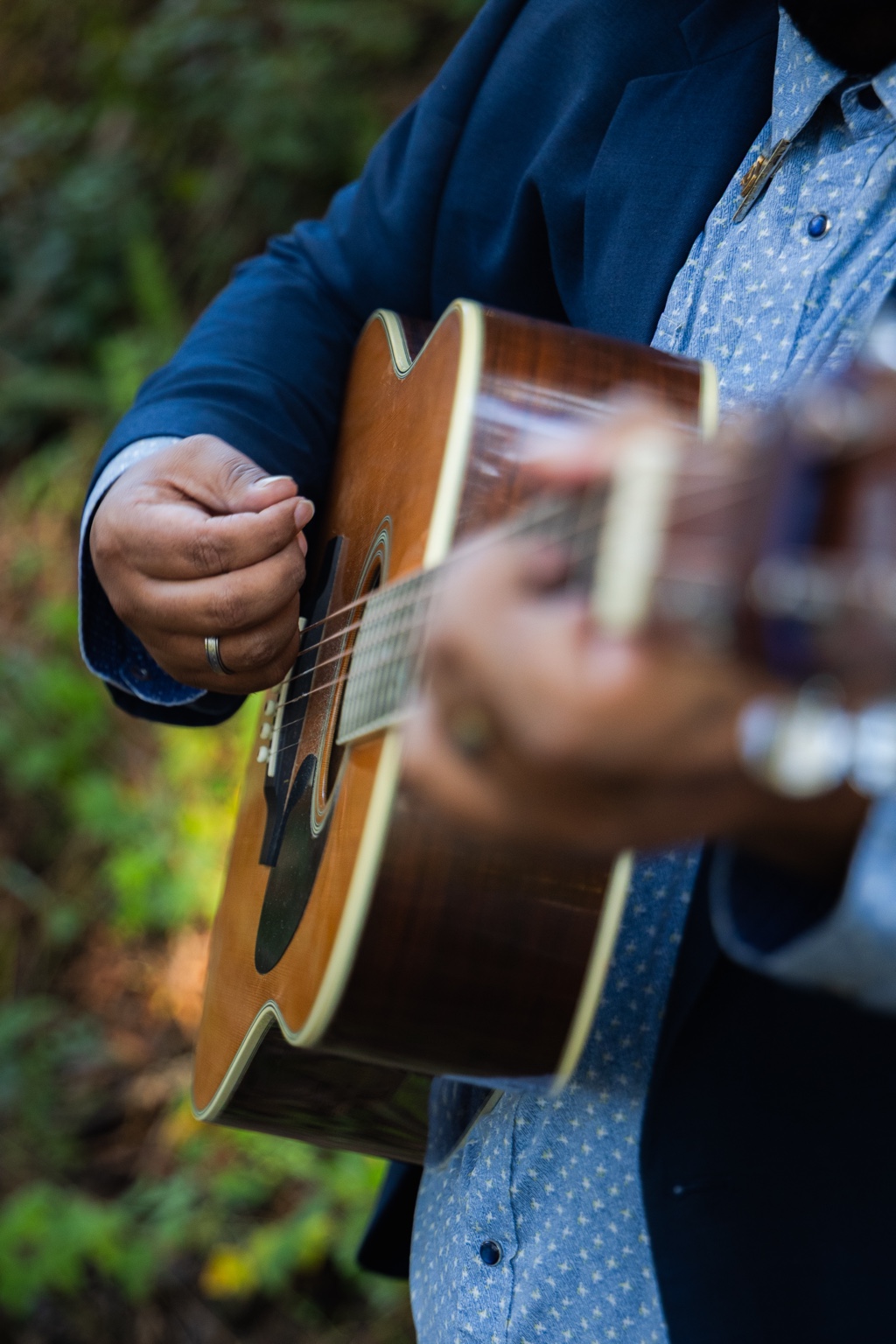 Pat Brown Jr playing acoustic guitar.