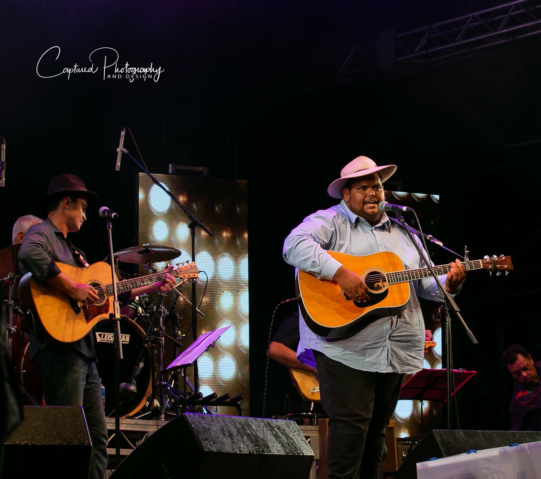 Pat Brown Jr performing live with acoustic guitar.